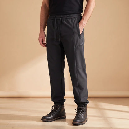 WARM TRAIL JOGGERS in black, men's fleece-lined softshell joggers with zip pockets and cuffed hems