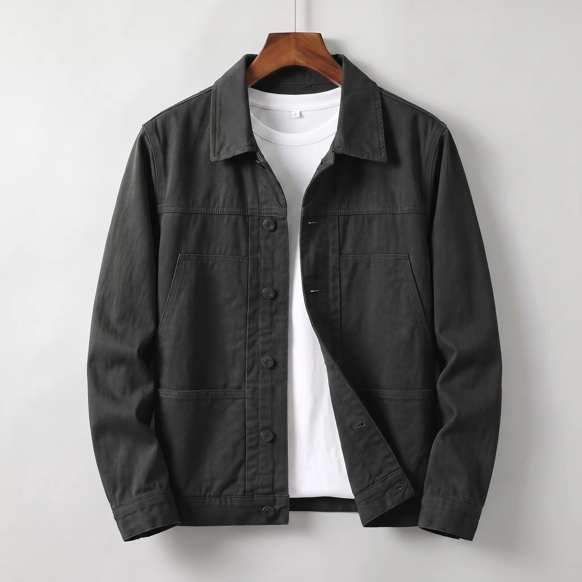 Washed chore jacket in black cotton twill with welt chest pockets and button front