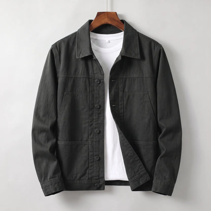 Washed chore jacket in black cotton twill with welt chest pockets and button front
