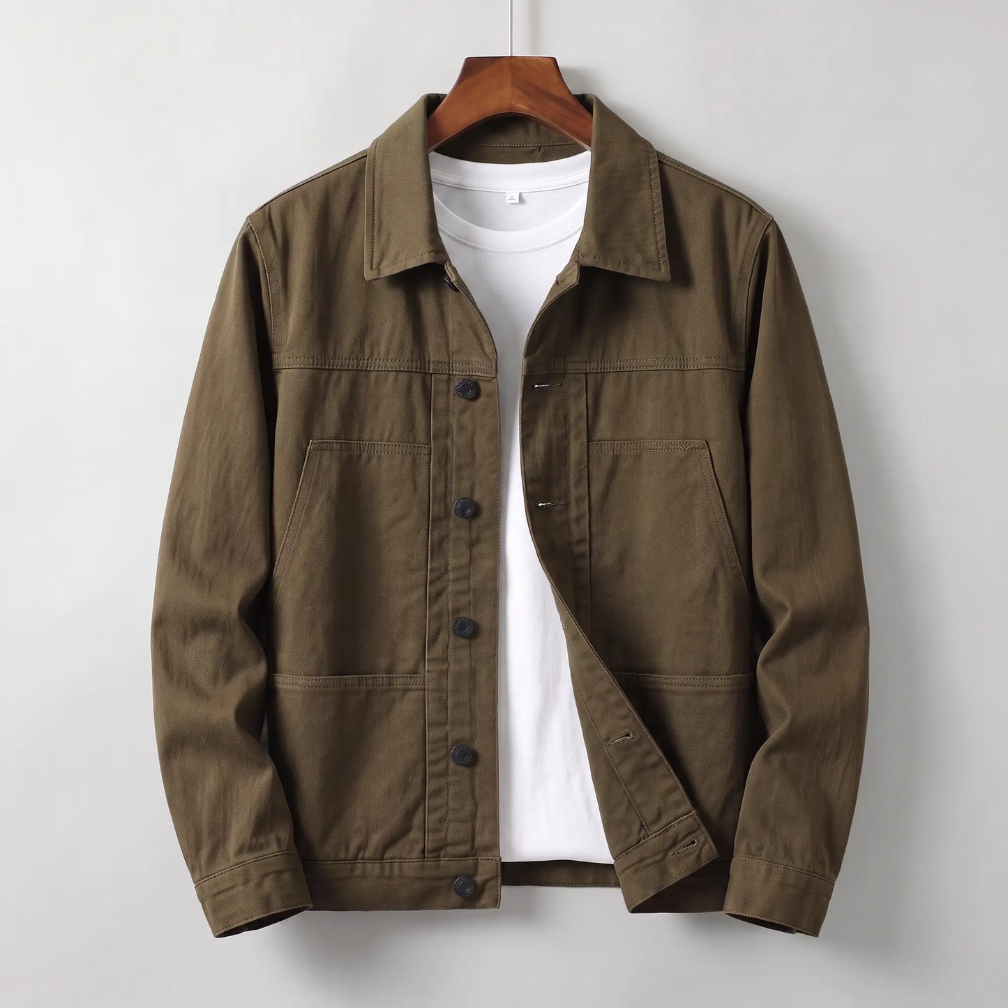 Washed chore jacket in brown cotton twill with welt chest pockets and button front