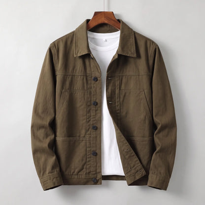 Washed chore jacket in brown cotton twill with welt chest pockets and button front