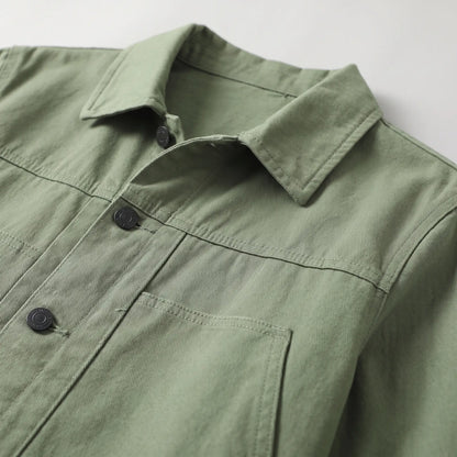 Close up of the collar, chest yoke seam and welt pocket on the green washed chore jacket