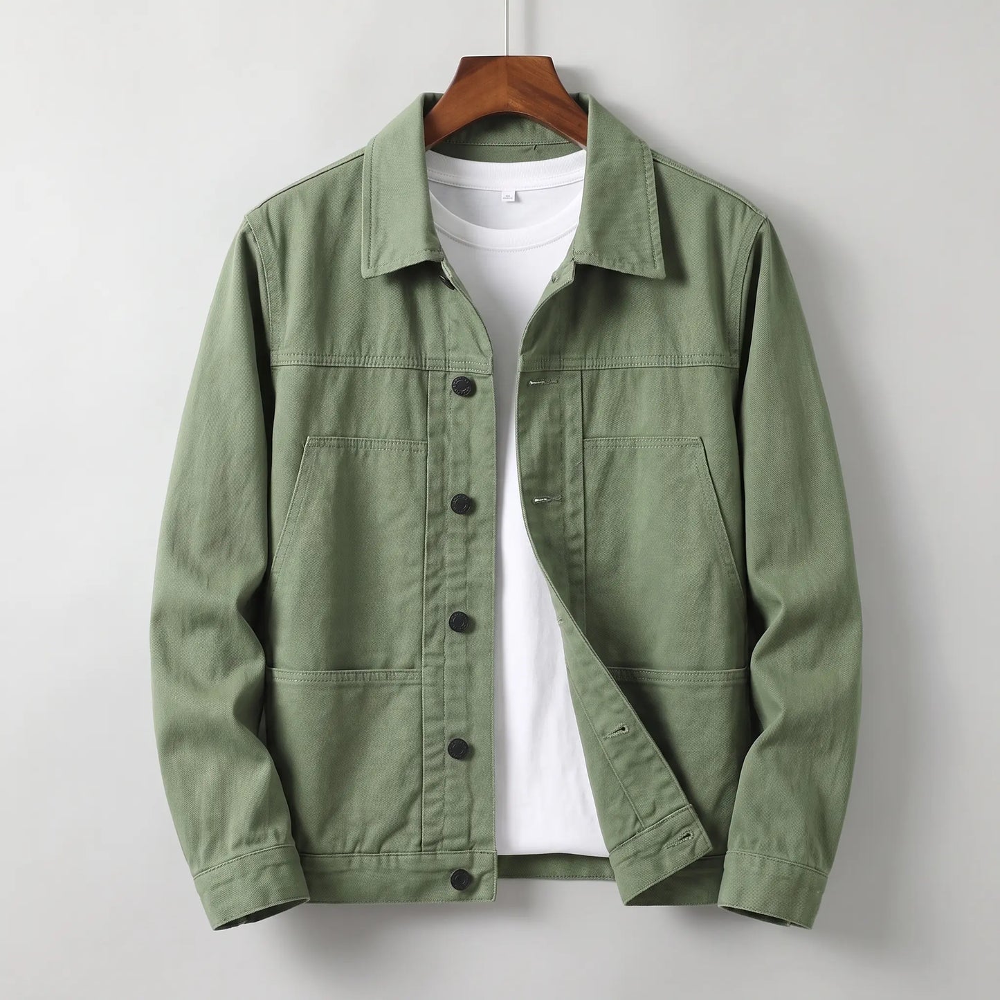Washed chore jacket in green cotton twill with welt chest pockets and button front