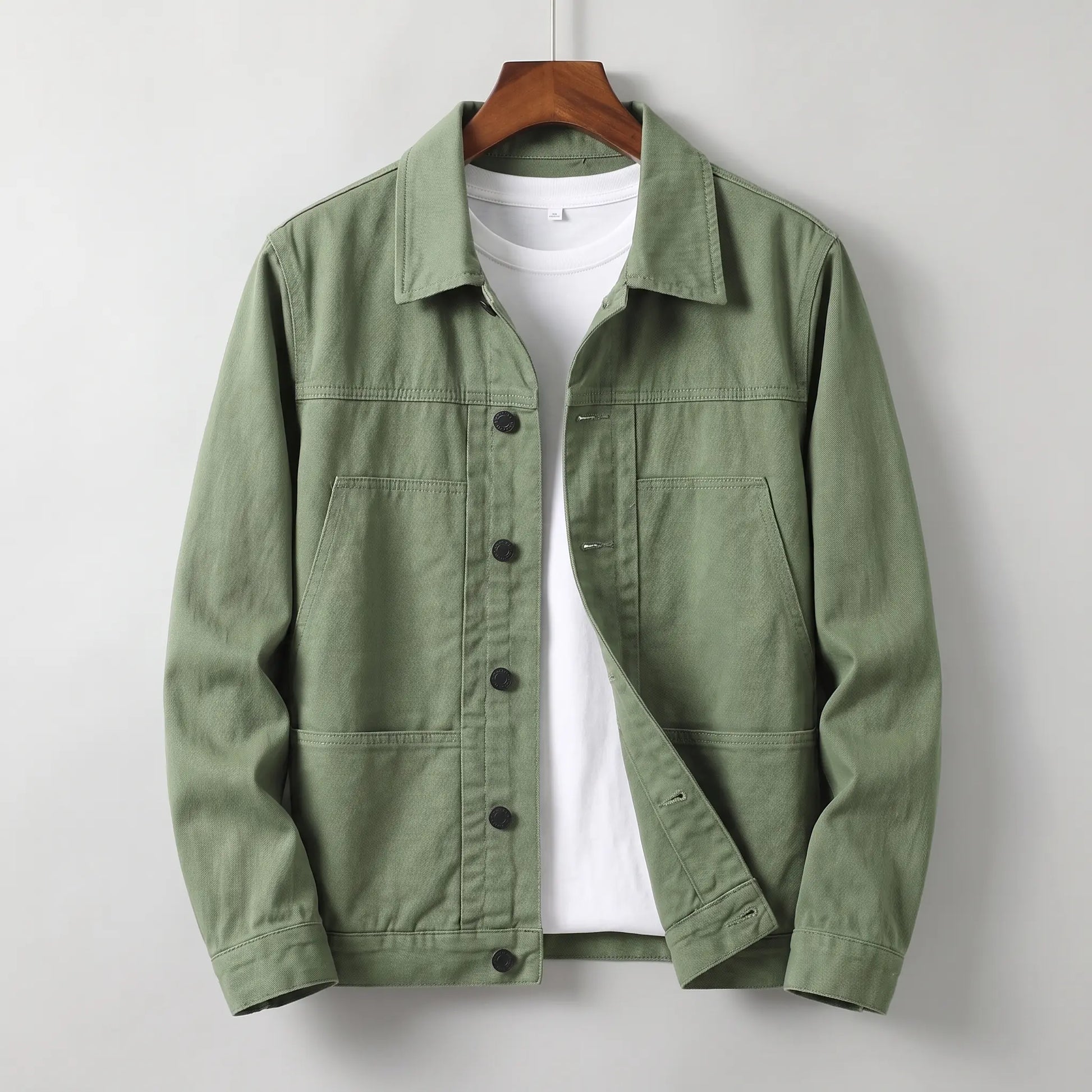 Washed chore jacket in green cotton twill with welt chest pockets and button front