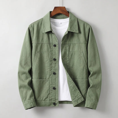 Washed chore jacket in green cotton twill with welt chest pockets and button front