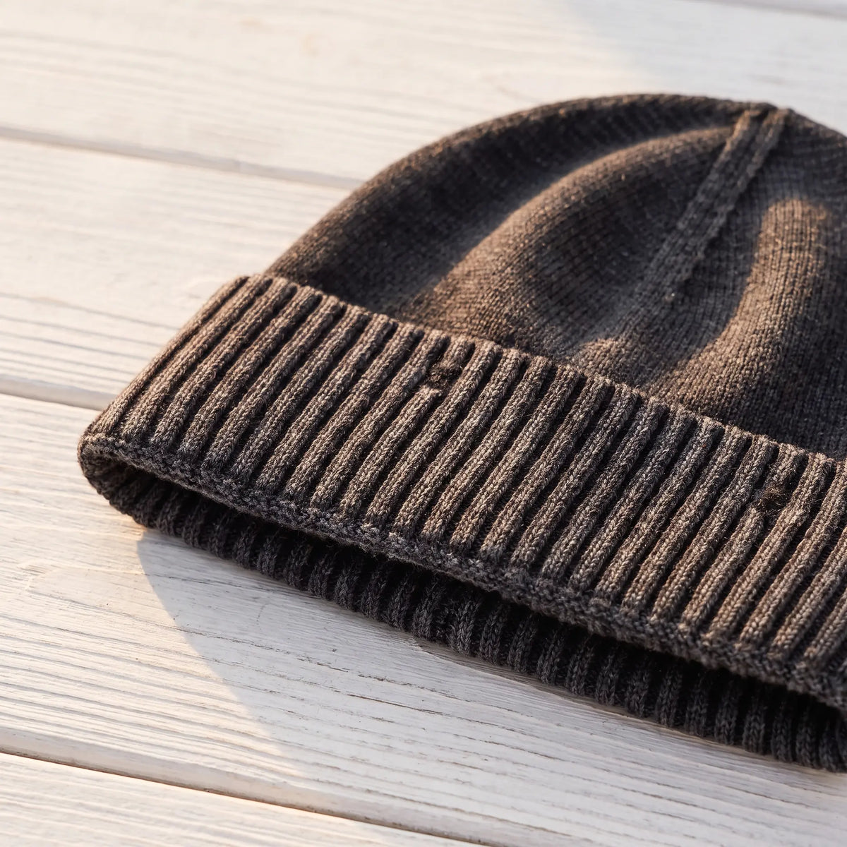 Close up of the deep ribbed cuff and washed knit on the black beanie