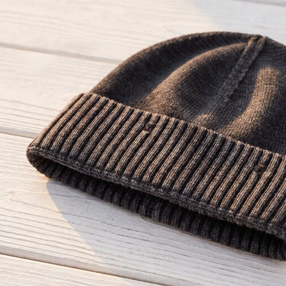 Close up of the deep ribbed cuff and washed knit on the black beanie