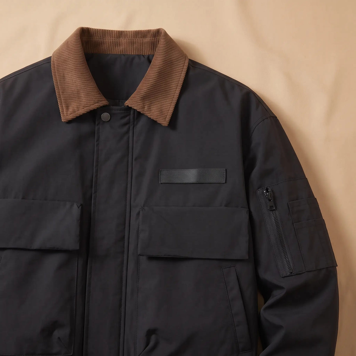 WEEKEND WORK JACKET close-up of the corduroy collar, chest pocket and sleeve zip, black