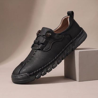 Men's black leather whipstitched moc-toe casual shoe with black ridged sole