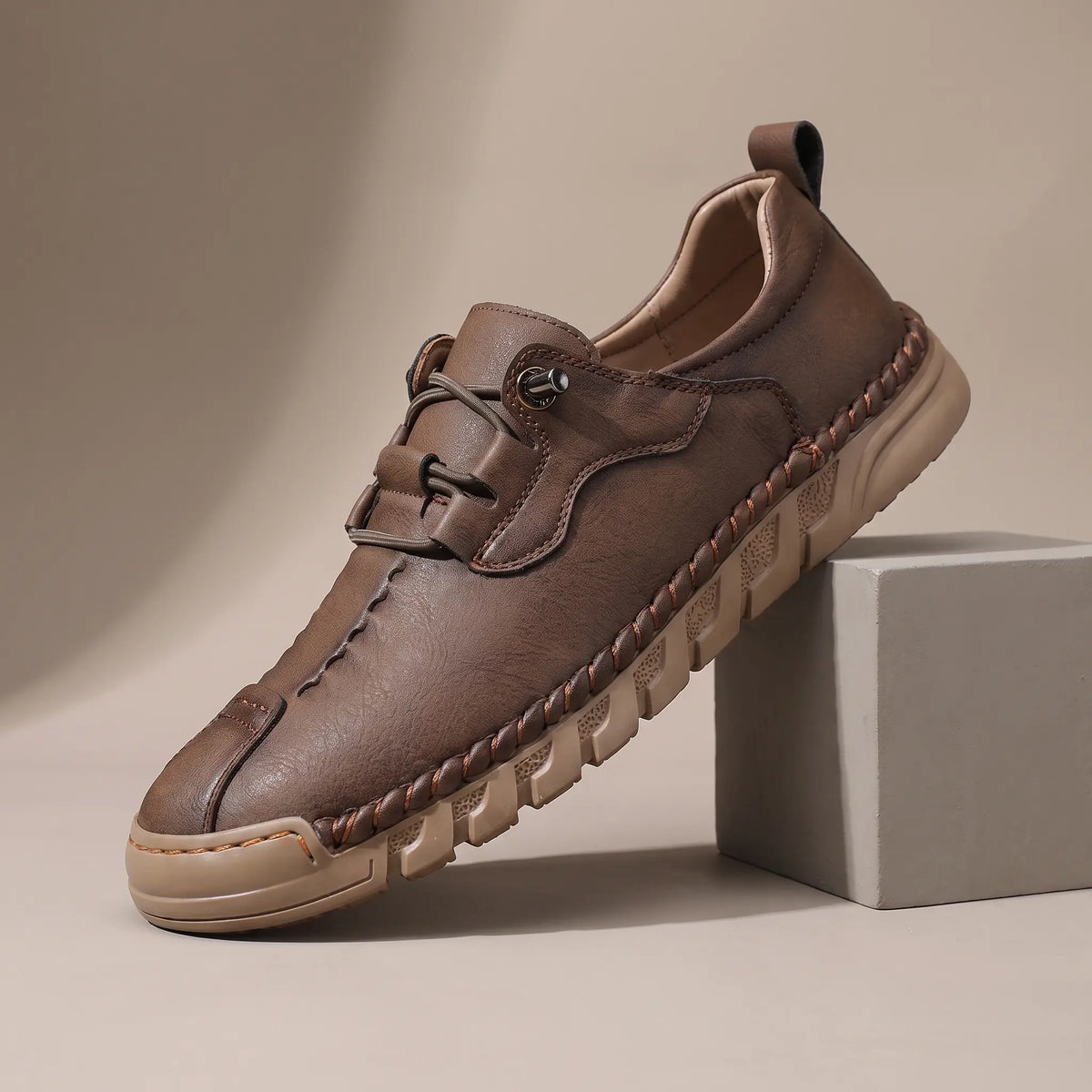 Men's brown leather whipstitched moc-toe casual shoe with thick ridged tan sole
