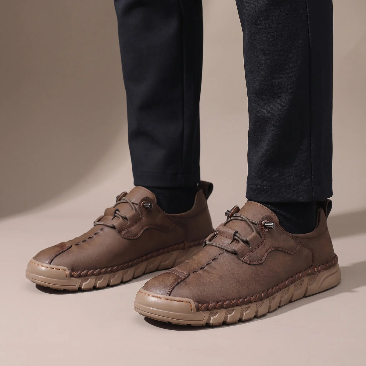 Man wearing the brown whipstitch casual shoes with dark trousers
