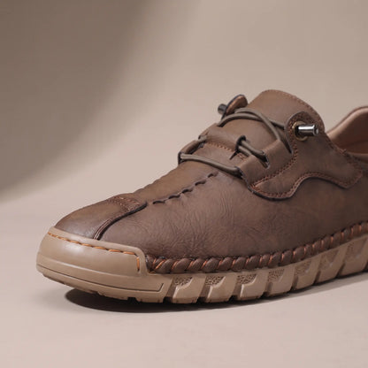 Close-up of the whipstitched moc toe and lacing on the brown casual shoe