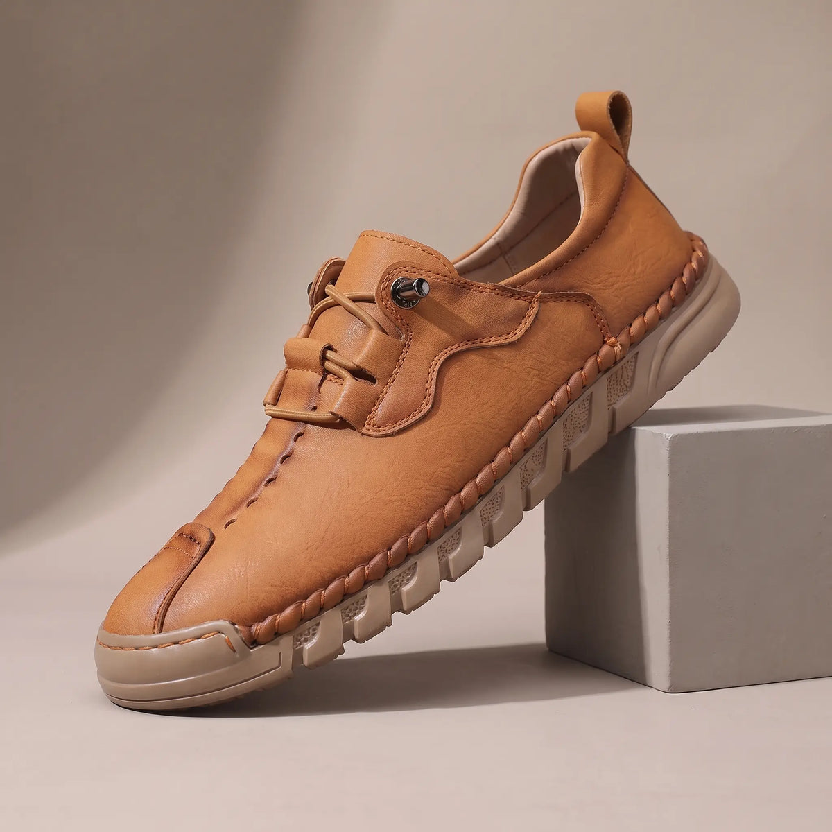 Men's tan leather whipstitched moc-toe casual shoe with thick ridged sole
