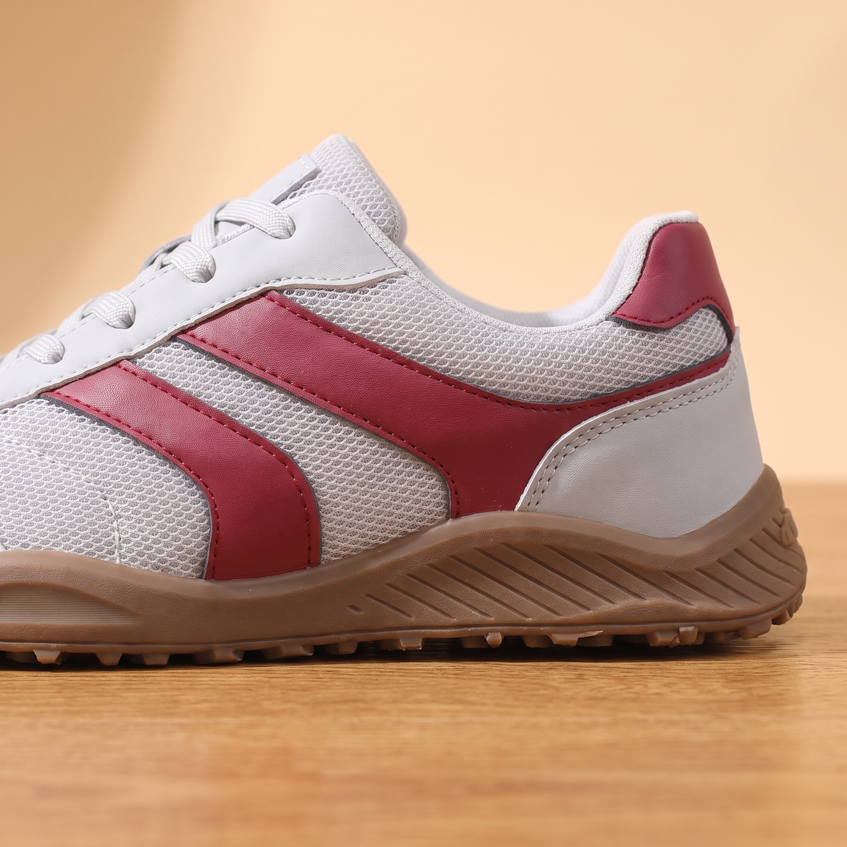Close-up detail of the Wide Toe Trail Sneakers side stripes and ribbed gum midsole