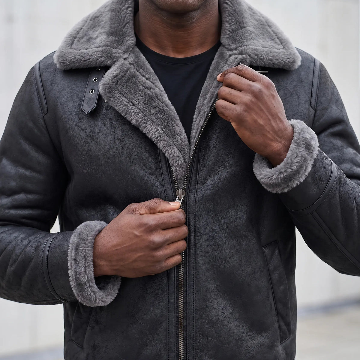 Man zipping up the WIDE COLLAR JACKET, close view of the front closure