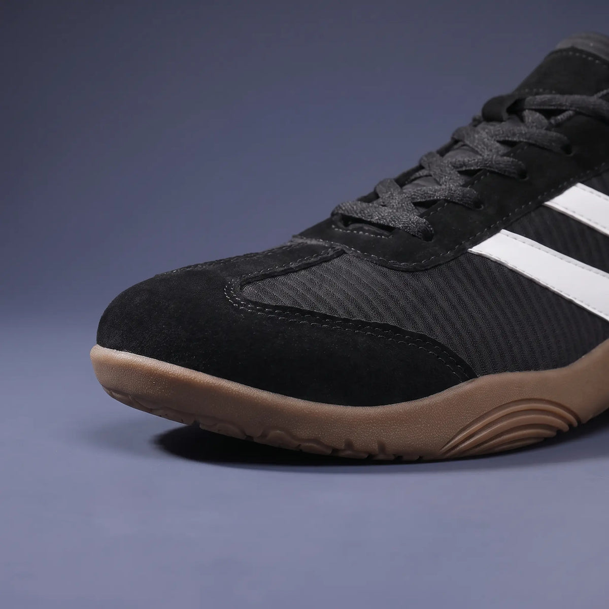 Front close up of black wide toe sneakers showing the wide toe box and thin gum sole