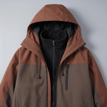Close up of the hood, zip-in fleece collar and zipped chest pocket on the brown windproof hiking jacket