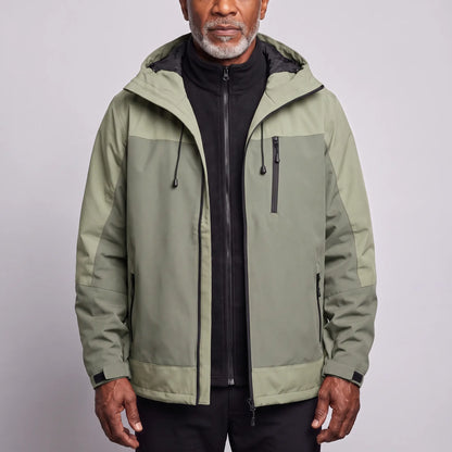 Men's green waterproof hooded hiking jacket in two tones of sage, worn open over a black fleece