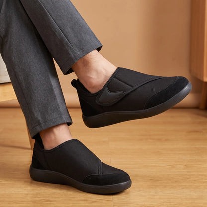 Man wearing black strap slip-on shoes with grey trousers