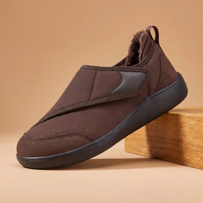Men's brown warm lined strap slip-on shoe on an oak block