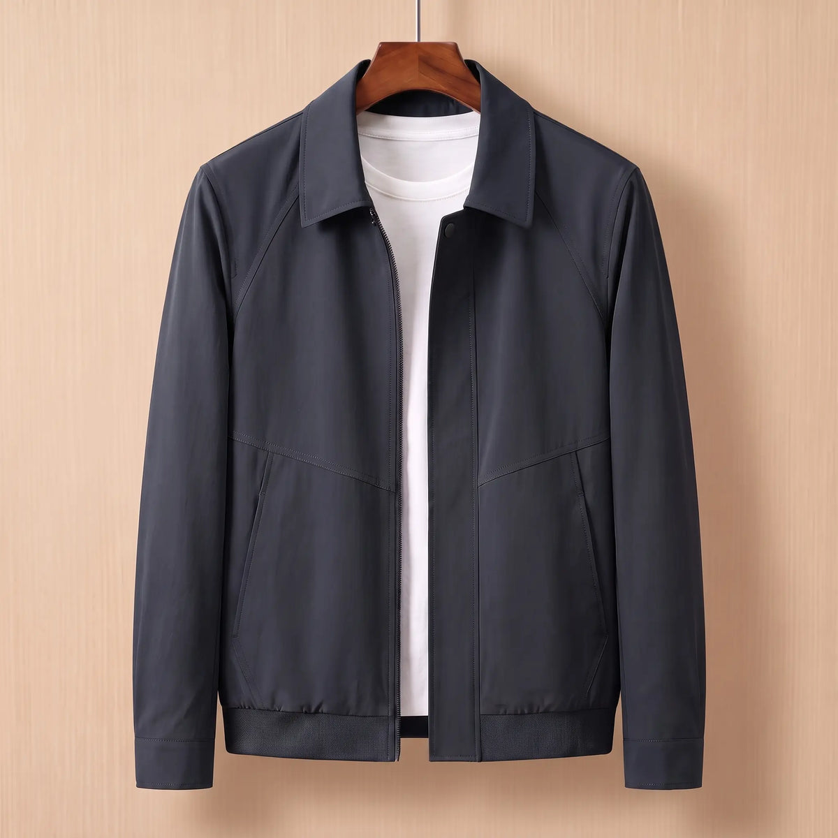 Zip front harrington jacket in navy blue on a wooden hanger