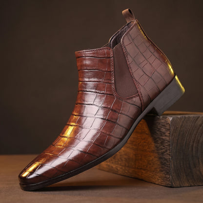 CROC GRAIN BOOTS deep-brown croc-texture platform Chelsea boot on a smoked-oak block, moody amber light
