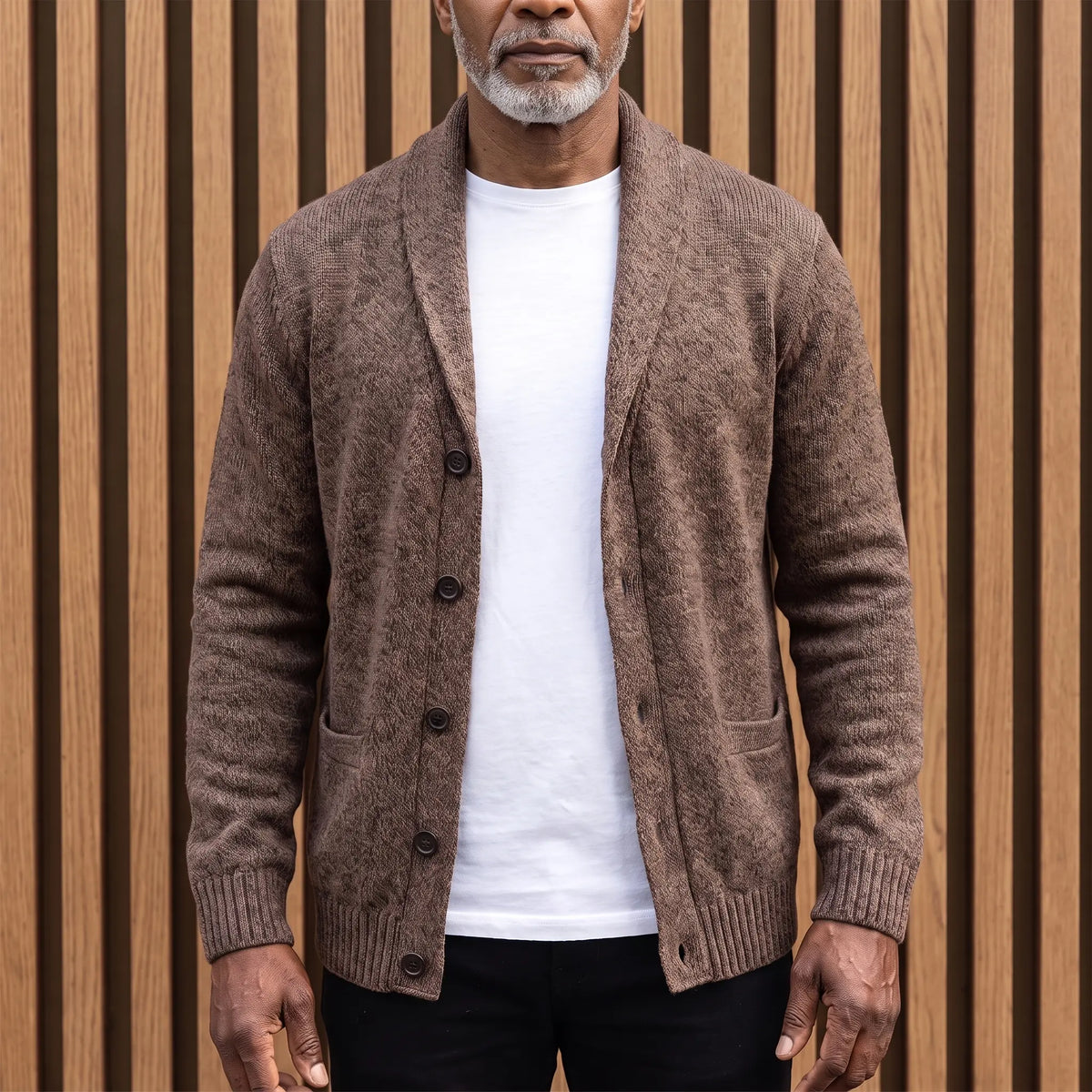 Men's brown flecked knit shawl collar cardigan worn open over a white tee