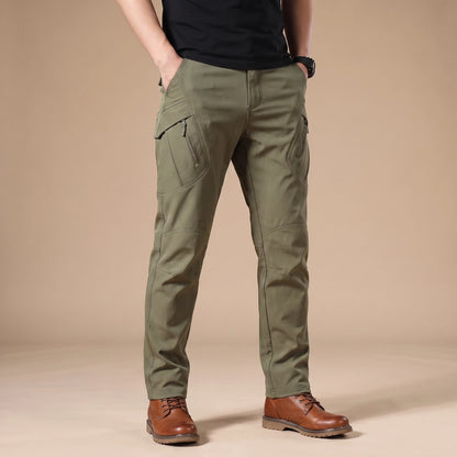 Stretch cargo trousers in green, worn front view in a warm studio