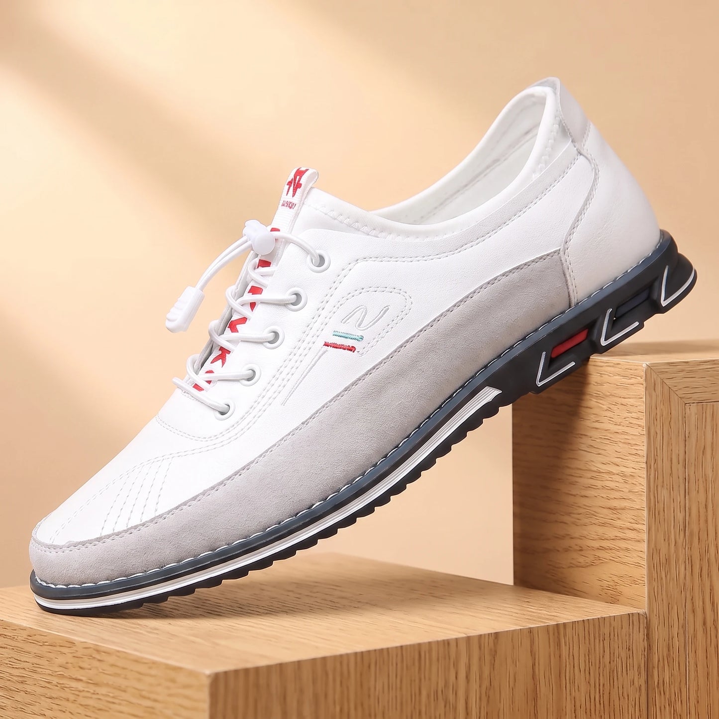 SMART CASUAL SNEAKERS white casual leather sneaker on a light oak platform, warm daylight