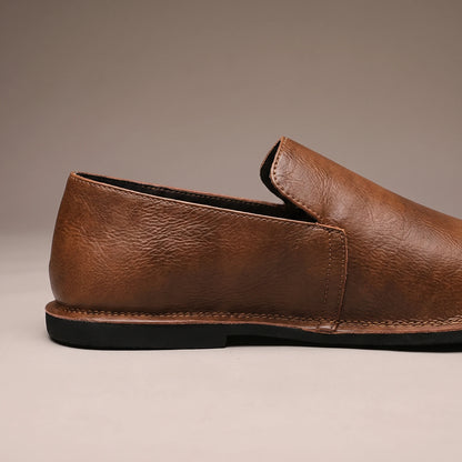 CLASSIC SLIP-ON LOAFERS side-profile close-up showing the leather grain and thin rubber sole edge