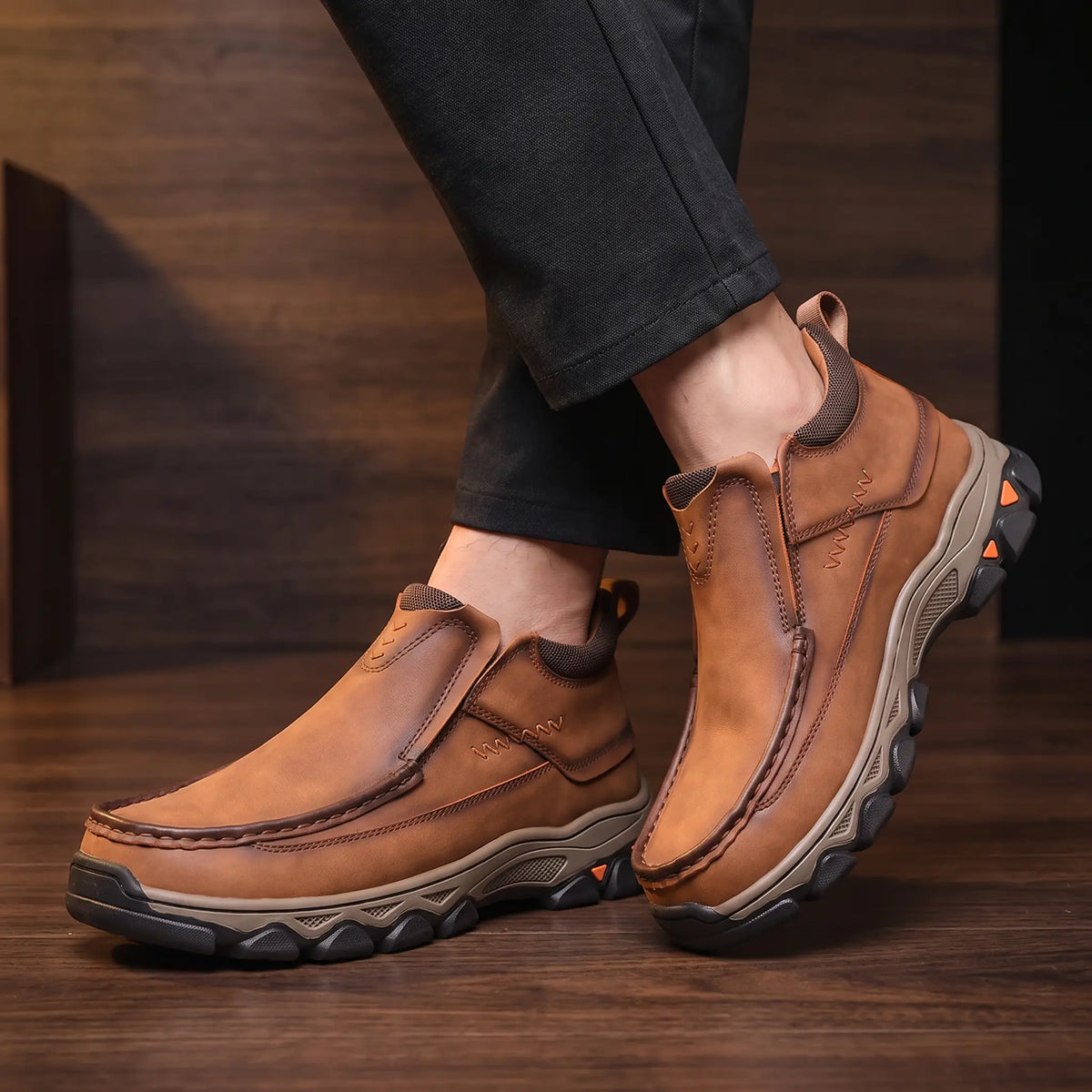 Man wearing Apron Toe Shoes with dark trousers in a warm wood interior