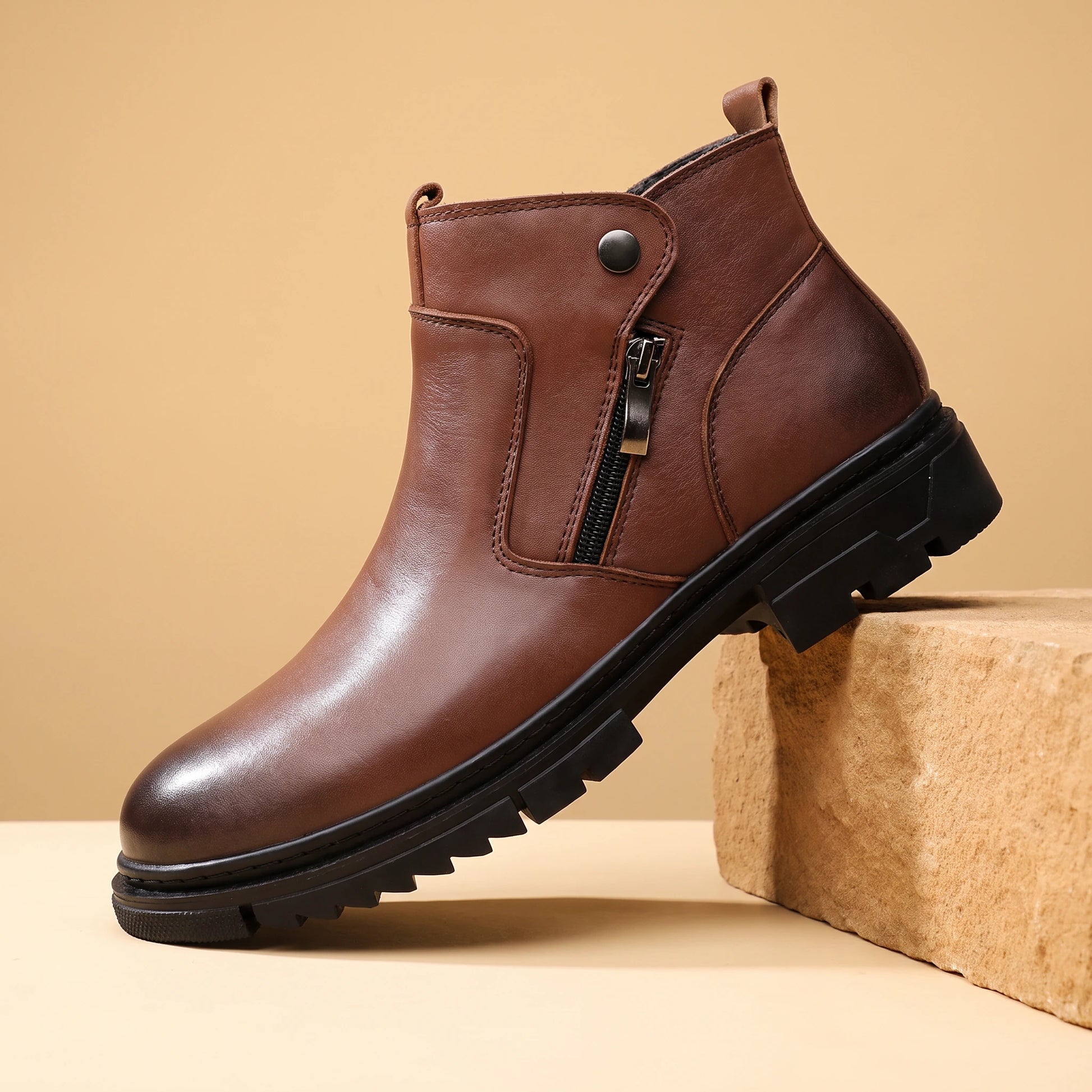 SHARP ZIP ANKLE BOOTS brown leather high-top side-zip boot on a warm sandstone block