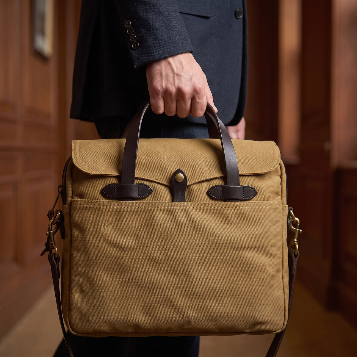 Man carrying waxed canvas laptop briefcase at his side