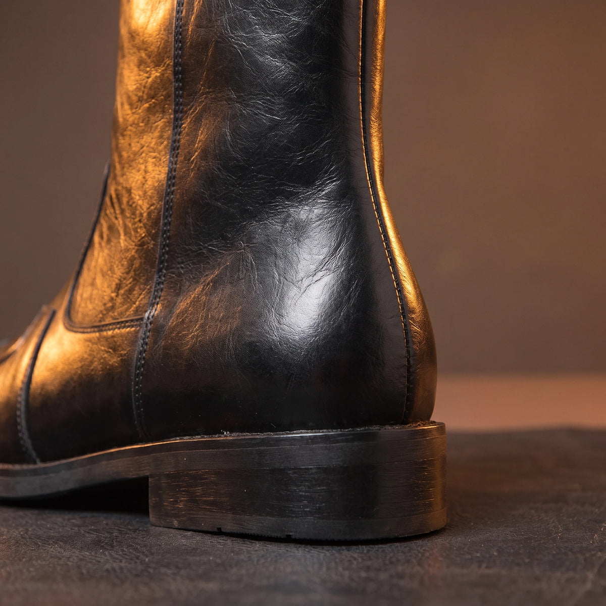 Close-up of black leather boot stacked heel and back