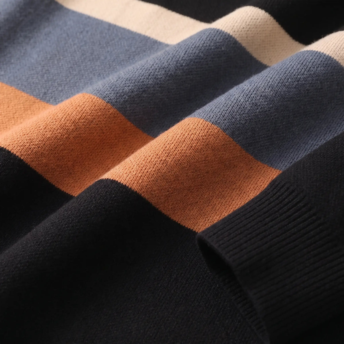 Close up of the knit texture where the colour bands meet on the black orange Chest Band Knit