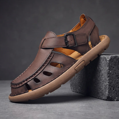 Brown Roman leather sandal on charcoal block