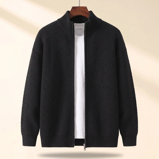Cold Weather Cardigan in black, a thick ribbed knit full zip cardigan jacket with a stand collar on a wooden hanger