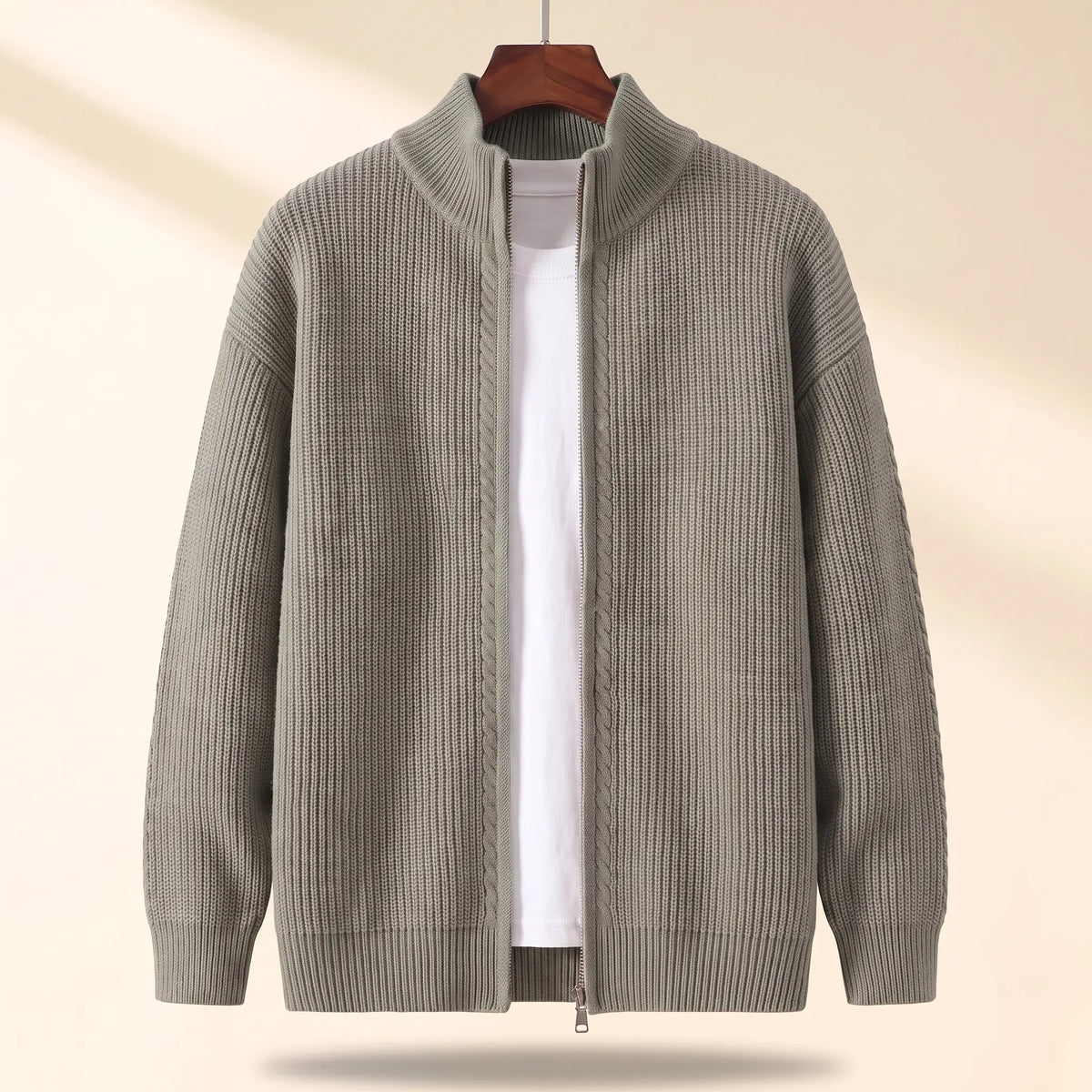 Cold Weather Cardigan in green, a thick ribbed knit full zip cardigan jacket with a stand collar on a wooden hanger