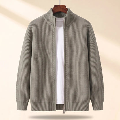 Cold Weather Cardigan in green, a thick ribbed knit full zip cardigan jacket with a stand collar on a wooden hanger