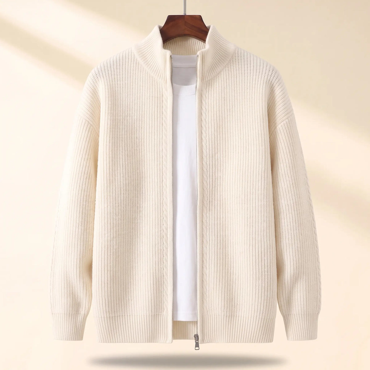 Cold Weather Cardigan in white, a thick ribbed knit full zip cardigan jacket with a stand collar on a wooden hanger