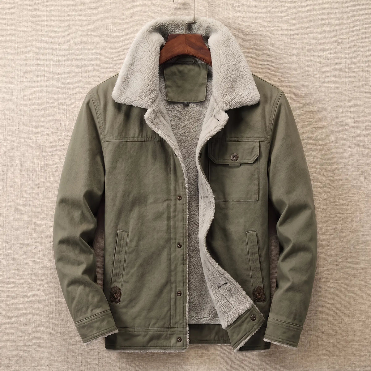 Green cotton canvas sherpa lined jacket on a wooden hanger