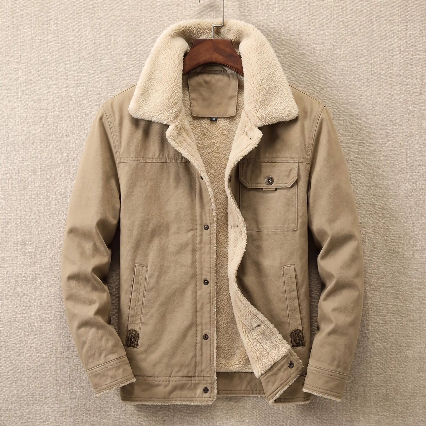 Khaki cotton canvas sherpa lined jacket on a wooden hanger