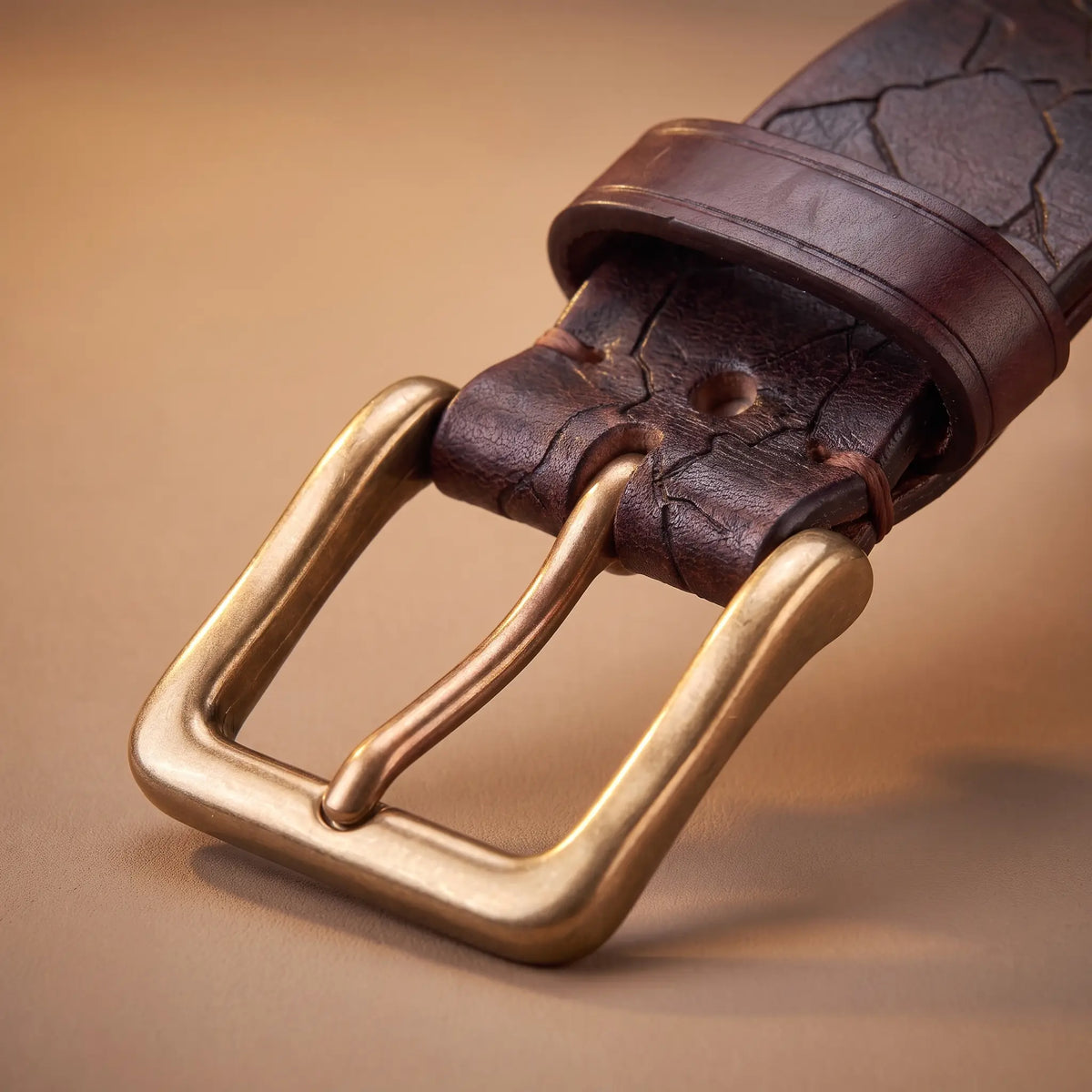 Close up of the solid brass buckle and leather keeper loop on the Cracked Texture Belt