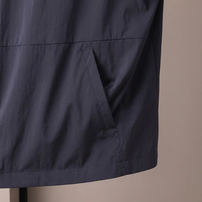 Close up of the slanted welt hip pocket and straight hem on the navy Crease Free Jacket