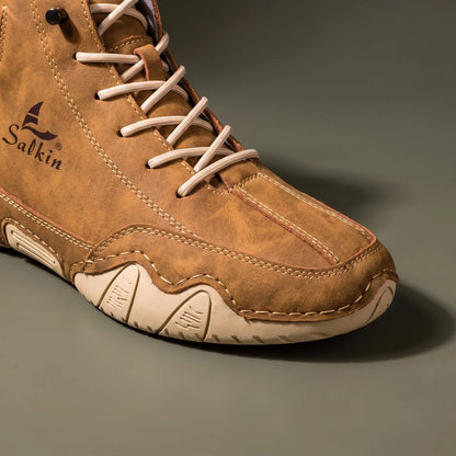 Close-up of the moc toe stitching and cream wave sole on the tan brown ankle boot
