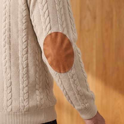 Close-up of the oval tan elbow patch and ribbed cuff on the khaki cable knit henley