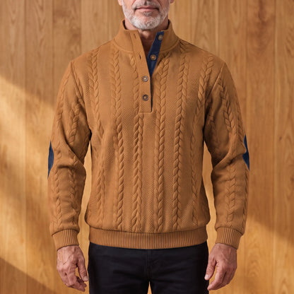 Men's tobacco brown cable knit henley sweater with stand collar, three-button placket and navy elbow patches, worn