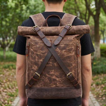Man wearing the waxed canvas roll top backpack in a park