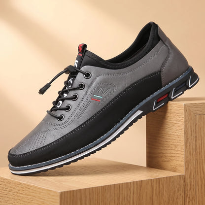 SMART CASUAL SNEAKERS grey two-tone casual leather sneaker on a light oak platform, warm daylight