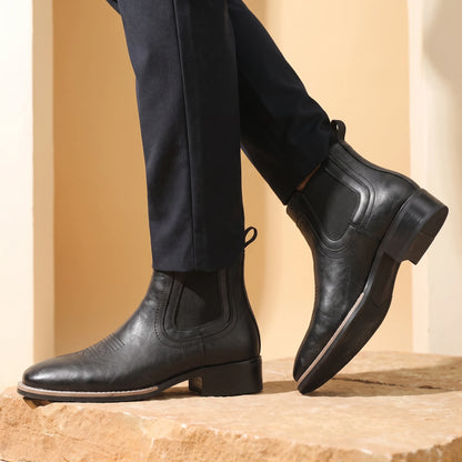 Man wearing black leather Chelsea boots mid-stride